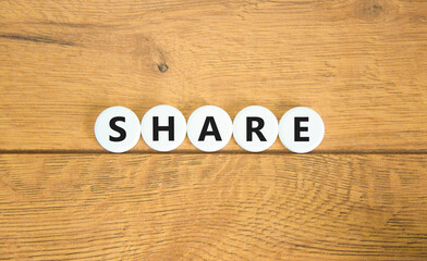 Share symbol. Concept word Share on beautiful white pills circles. Beautiful wooden table wooden background. Business lifestyle share concept. Copy space.