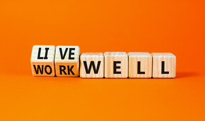 Live or work well symbol. Concept words Live well Work well on wooden cubes. Beautiful orange table orange background. Business and live or work well concept. Copy space.