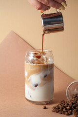 Various coffee drinks with chocolate truffles, beans and milk on beige background. Cozy flat lay for cafes, baristas, dessert menus, social media and coffee branding.