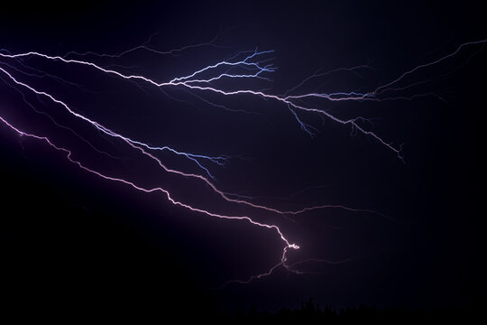 Lightning branches across a dark stormy sky