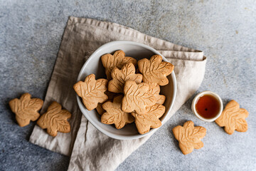 Top view of maple leaf shaped cookies on gray background