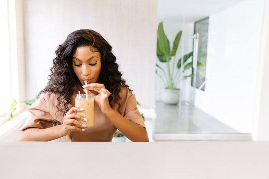 Woman enjoying coffee in a modern workspace