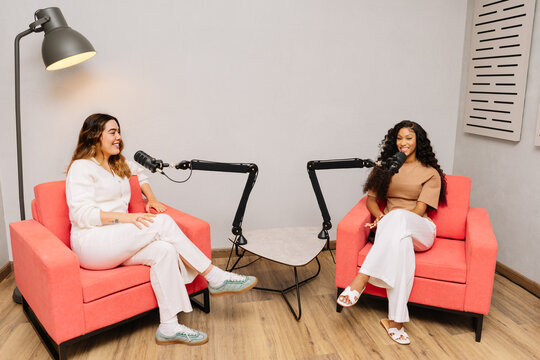 Latin women podcasting in a modern studio environment