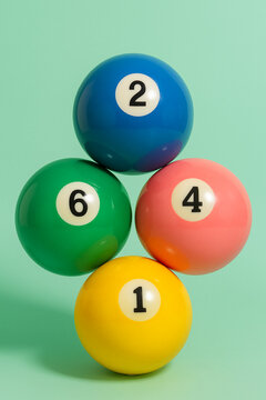 Pastel billiard balls with vibrant colors on mint background