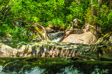 Landscape still shot of the Dure River in Brousse and Villaret in the South of France. Small waterfalls and undergrowth in Occitanie.
