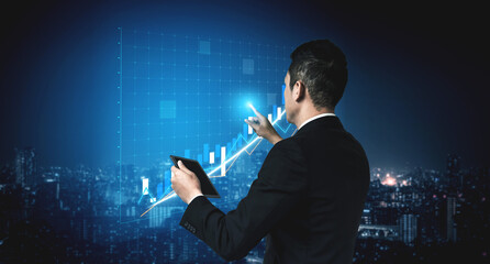 A businessman in formal attire engages with financial data on a digital tablet, set against a night cityscape, showcasing growth and technological integration. Impute