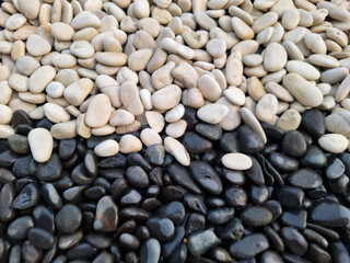 half white and half black flat round pebble stones background
