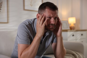 Fototapeta premium Man suffering from panic attack at home