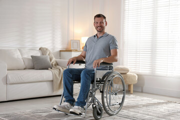 Happy man in modern wheelchair at home