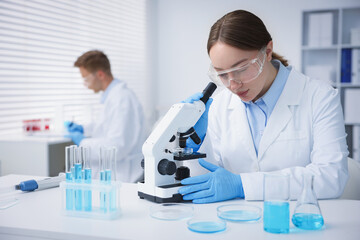 Fototapeta premium Medical analysis. Scientist working with microscope in laboratory, selective focus
