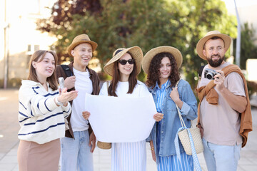 Guide with microphone and group of tourists on city street during excursion
