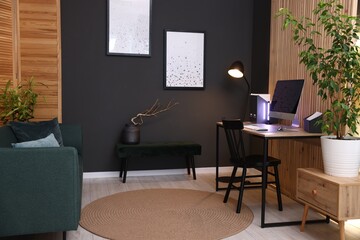 Stylish workplace with wooden desk, computer and chair indoors
