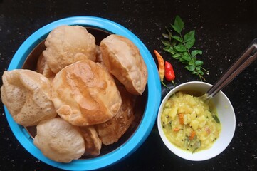 wheat poori masala also wheat poori curry is made with boiled potatoes, onions, tomatoes, whole spices and curry leaves. It is deep-fried, unleavened bread that is a popular Indian dish.