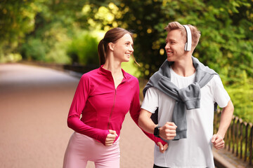Obraz premium Happy couple running in park. Morning exercise