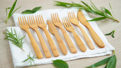 Natural bamboo cutlery set with fresh green herbs for eco friendly dining