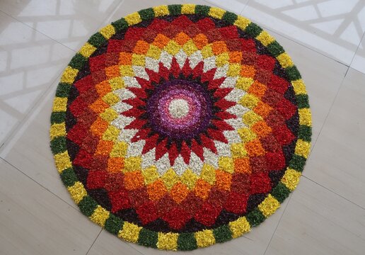 pookalam designs for onam celebrations , pookalam made for part of onam celibration in kerala, india. it also referred to as athapookalam, is often made in a circular shape with flowers on floor
