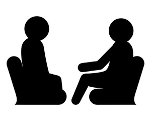 Two People Sitting in Chairs in a Dialogue or Therapeutic Setting