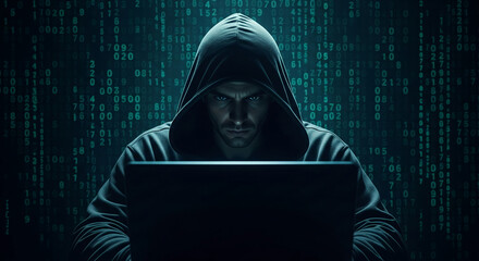 Person in dark hoodie sits before laptop, green digital code background, conveying themes of cybersecurity, hacking, or data privacy