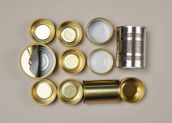 Sorting garbage for recycling. Used empty tin cans on a gray background. Garbage separation concept, waste recycle, waste sorting.