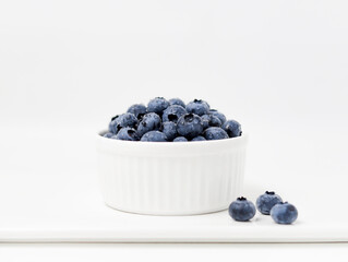 Blueberries in a bowl, Bowl of fresh blueberries on white board