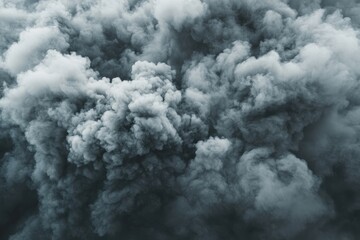 Gray smoke swirls against a dark background creating an abstract cloud formation, gray smoke abstract background