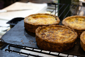 Small pies known as quiches on top of a rustic board