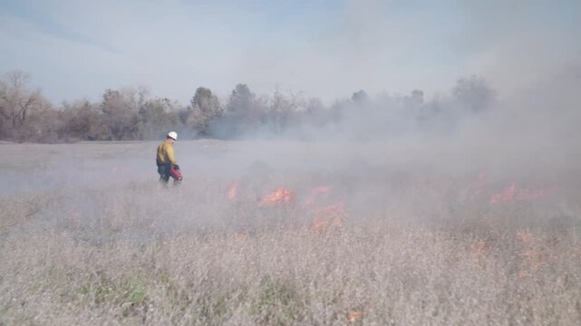 Fireman doing a controlled brush fire burn