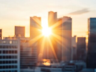 Blurred cityscape at sunset or sunrise with golden sunlight bursting between buildings