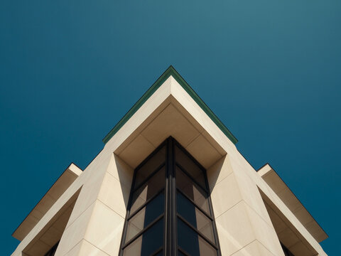 Geometric building corner against clear blue sky architecture