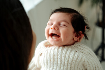 Obraz premium a mother's or father's hands holding a baby, the birth of a child, parental love and care, mother and child