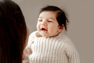 Obraz premium a mother's or father's hands holding a baby, the birth of a child, parental love and care, mother and child