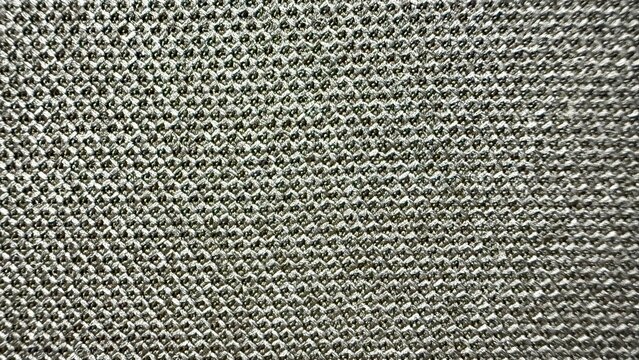 shiny silver diamond knit textile closeup with reflective texture ideal for fashion design and upscale upholstery