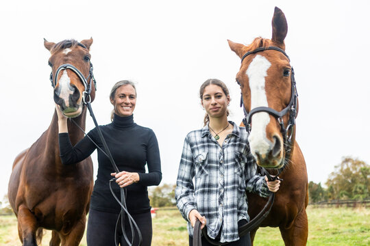 Mother and daughter enjoying day with horse on New Zealand farm