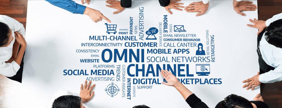 Close-up view of a collaborative workspace featuring hands pointing at digital marketing concepts like omni-channel strategies and customer engagement methods. Amity