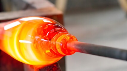 Molten Glass Blowing: A craftsman shapes fiery molten glass, highlighting the intense heat and the artistry of this ancient craft.