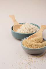 Whole grain and amaranth flour in a bowl on a light background. Healthy eating concept, vegan.
