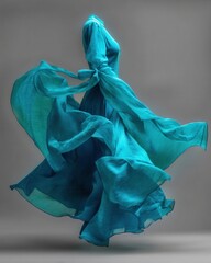 Elegant teal dress swirling gracefully in motion