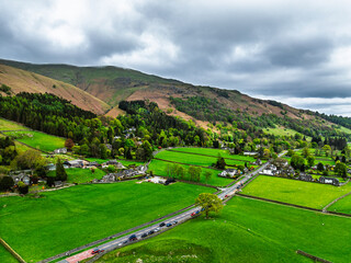 Farms and Mountains over road A591 from a drone, Grasmere Lake, Grasmere, Ambleside, Lake District, Westmorland, Cumbria, UK