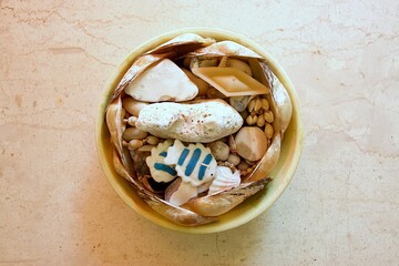 Bowl of coastal treasures on a marble surface