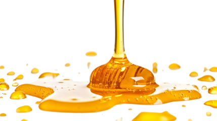 A honey drips down a white surface. The honey is golden and thick. The honey is dripping from a spoon