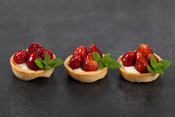 Mini Round Strawberry tartlets. Dark gray background