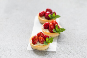 Mini Round Strawberry tartlets. Light gray background