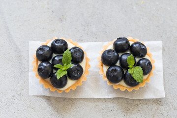 Two round Blueberry tartlets. Light background. Top view