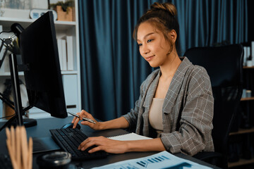 Beautiful businesswoman working on laptop for marketing plan on social media online, searching data...