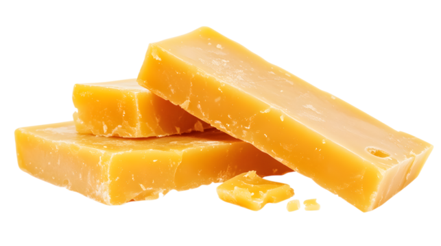 Three yellow blocks of butter are stacked on top of each other. The butter is cut in half, revealing a yellow center