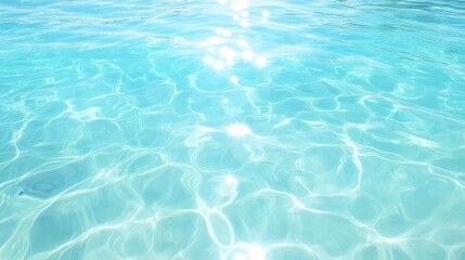 Obraz premium Turquoise water surface with sun reflections ripples and light play