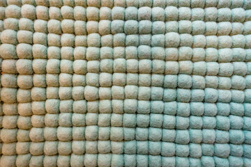 Textured fabric surface with soft, rounded shapes creating a cozy and inviting atmosphere