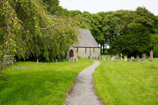 Sheldon, The Peak District, England &mdash; August 6 2025: Historic stone chapel and country churchyard surrounded by summer greenery in rural Sheldon, The Peak District, England.