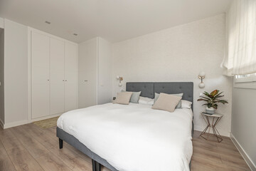 Boho chic style: Bedroom with a king-size bed, flowing curtains, and natural plants