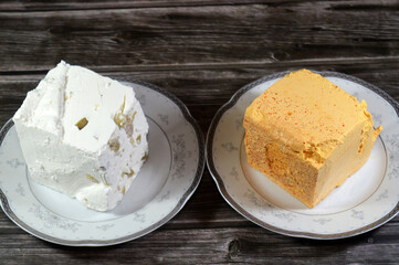 Feta, a Greek brined white cheese made from sheep milk or from a mixture of sheep and goat milk, soft, with small or no holes, and no skin, yellow with turmeric and pepper, white cheese with olives